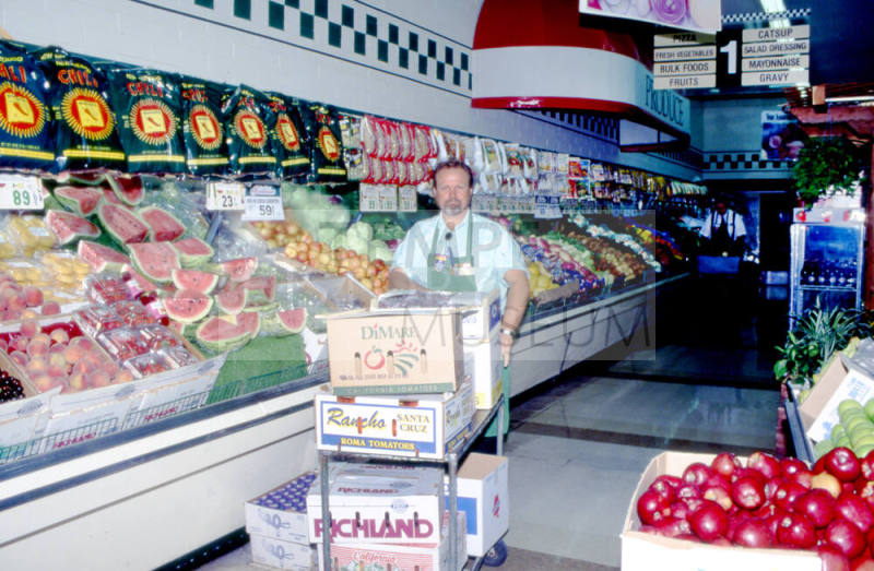 Store employee with boxes, Stabler's Market, University Dr. and Mill Ave.