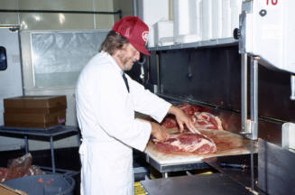 Employee in meat department, Stabler's Market, University Dr. and Mill Ave.