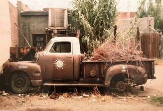 Old Pickup Truck With Sun Emblem on Door