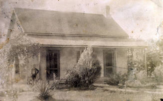 Exterior photo of Dr. Fenn J Hart's Tempe home with Earl Brown on porch