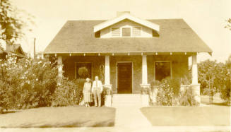 Dr. Fenn J Hart with his wife Mrs. Rosa Brown Hart in the front yard of their Phoenix home