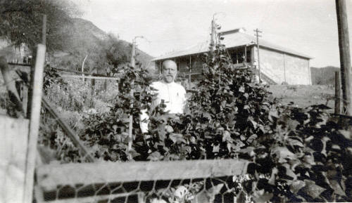 Dr. Fenn J Hart standing in a vegetable garden