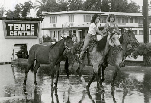 Girls Ride Horses Through Flood Waters