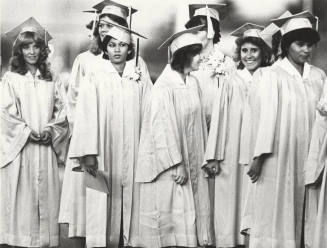 Young Women in Graduation Caps and Gowns