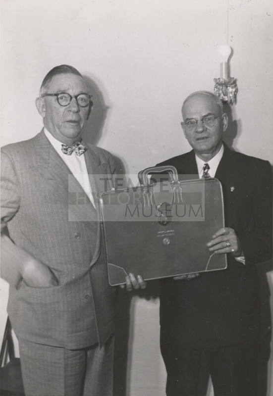 Photo- two men holding a briefcase