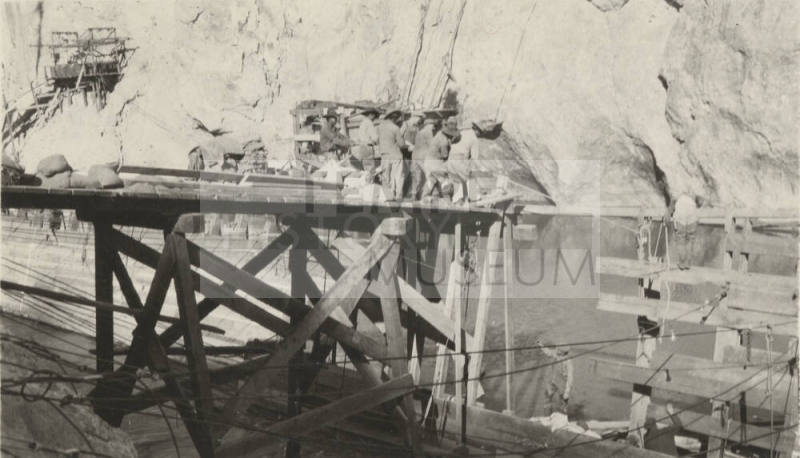 Photo- workers pulling rope at Mormon Flat dam