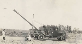 Photo- people standing near commercial Dodge truck with hoist