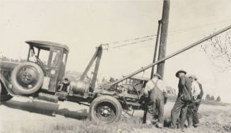 Photo- men installing power line with Dodge-Graham truck