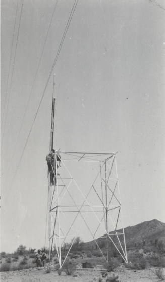 Photo- construction crew erecting a line tower