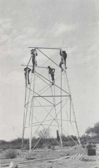 Photo- construction crew erecting a line tower