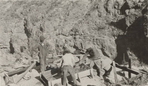 Workers pouring cement footers for Horse-Mesa Line
