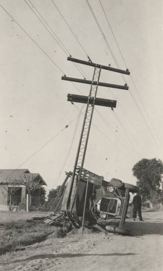 An overturned truck after colliding with the power line pole