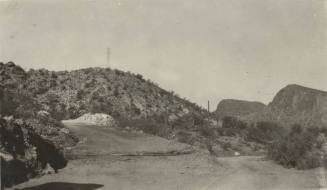 Photo-View of the high desert with roadway and power line tower