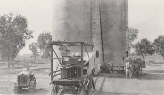 Photo-Overview of silos, generators,corn chopper and tractor