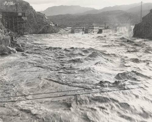 Photo-View of a flooded Verde River showing partial construction of Bartlett Dam