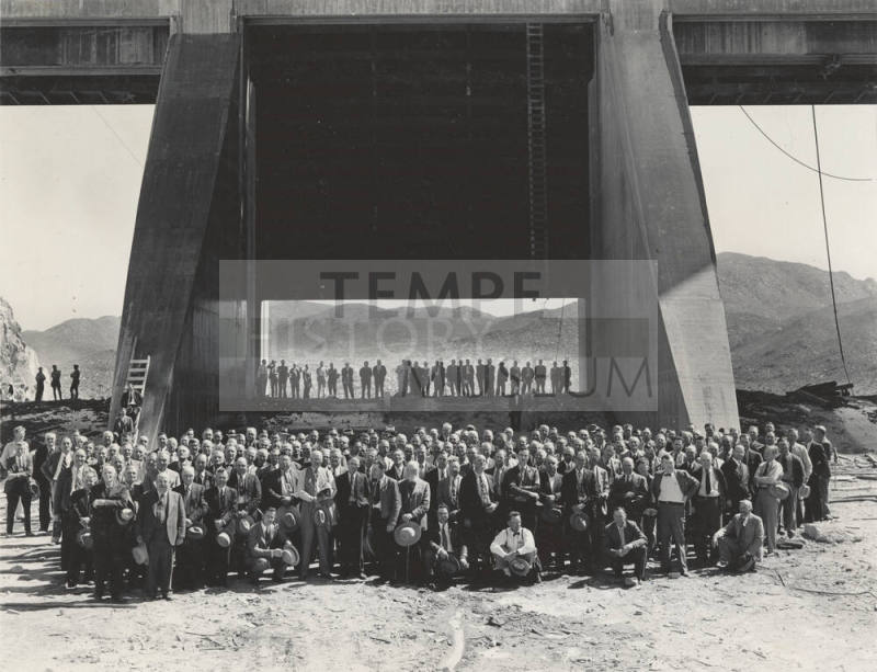 Photo- View of a large group of people in front  of the Bartlett Dam spillway