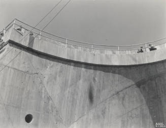 Photo- View of two workers standing on top of Bartlett Dam