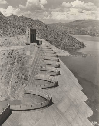 Photo- View of the top of Bartlett Dam with lake filled