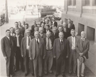 Photo-View of a group of men in front of an unknown building