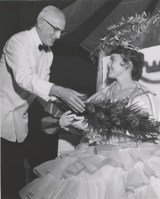 Acting President H. D. Richardson presents roses to Diane Huber