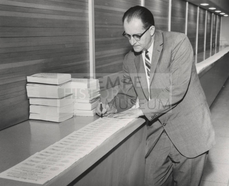Alfred Thomas Jr., signing diplomas for 1960 class