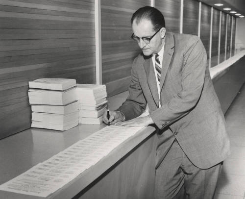 Alfred Thomas Jr., signing diplomas for 1960 class