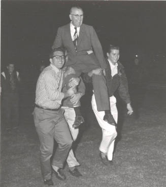 President Gammage is carried on students shoulders in celebration of name change