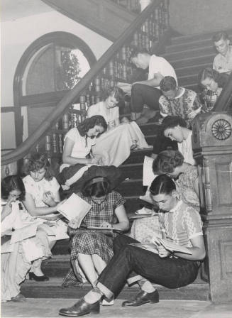 Students Sitting on Stairway Filling Out Registration Forms