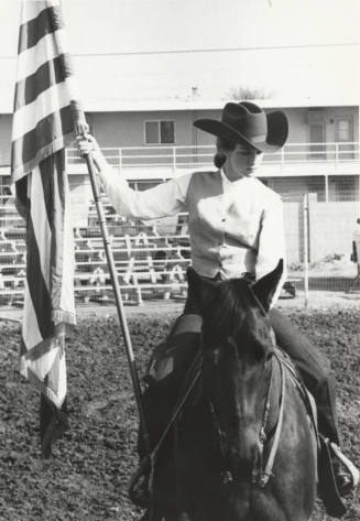 Cowgirl Mounted with Flag at Rodeo