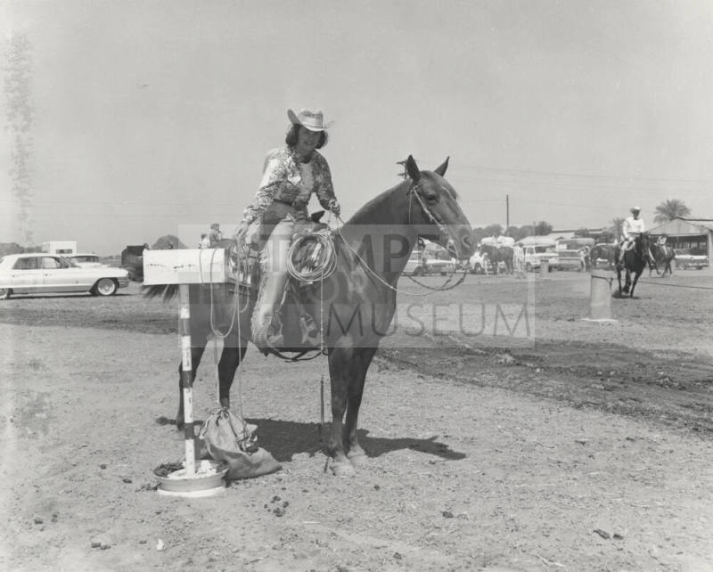 Woman Calf Roper on Horse at Rodeo