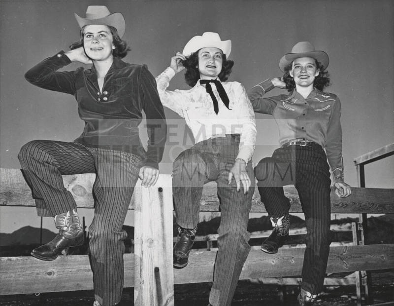Three Glamorous Cowgirls Posing on a Fence