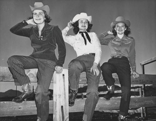 Three Glamorous Cowgirls Posing on a Fence