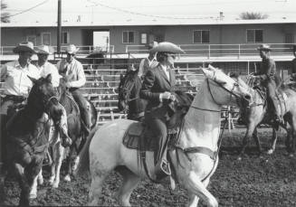 Five Men and One Woman on Horseback on Parade