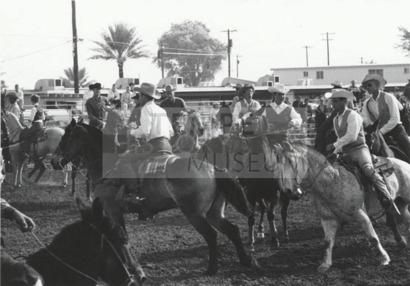 Competitors Riding in a Parade at a Rodeo