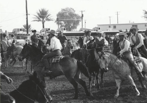 Competitors Riding in a Parade at a Rodeo
