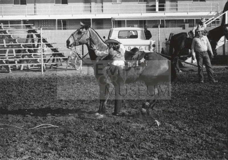 Lady Calf Roper Dismounts at the Rodeo