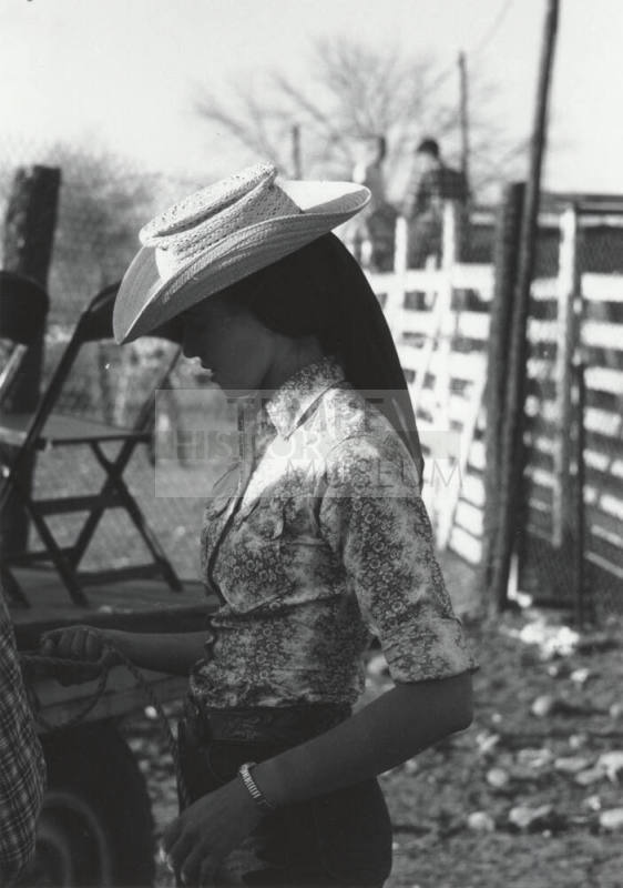 Lady Spectator Behind the Stands at the Rodeo