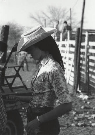 Lady Spectator Behind the Stands at the Rodeo