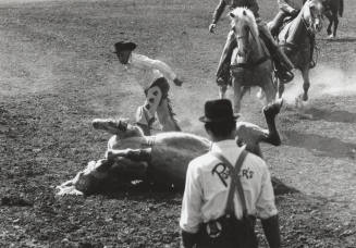 Bronc Rider and Horse Fall at the Rodeo