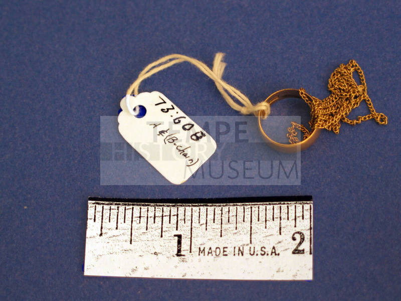 Small ring on gold link chain