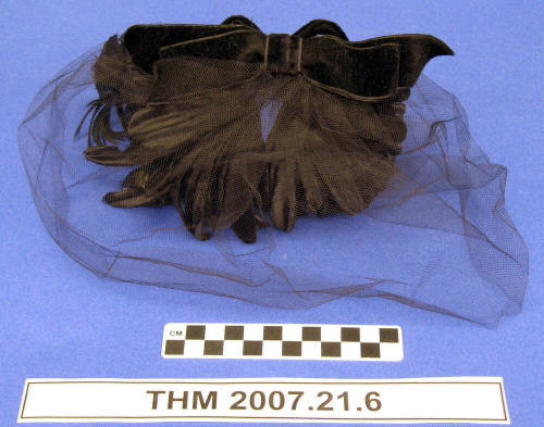 Black velvet flowers and feathers hat.