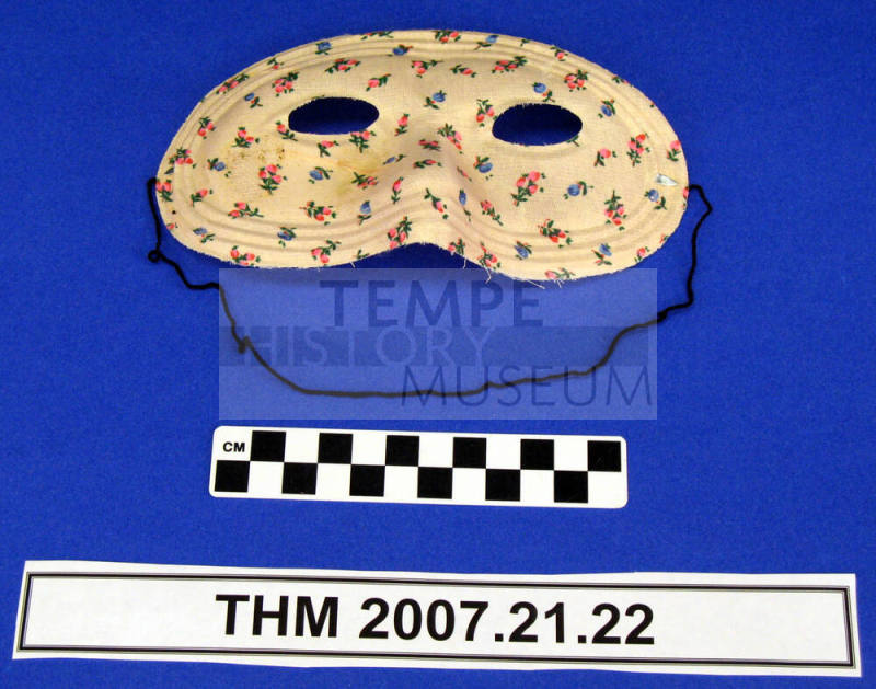 Pink flowered half mask.