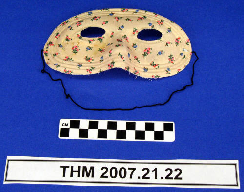 Pink flowered half mask.