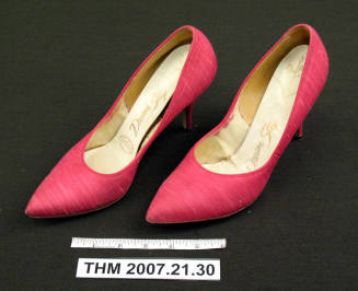 Pink fabric stilletto pumps.