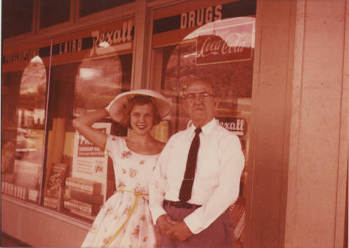 Connie Null Zimmerman and William E. Laird in front of the Laird Pharmacy, 1956