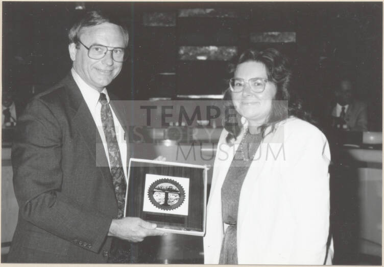 Photo of Harry Mitchell and Barbara Sherman with Framed City Seal, 1992.