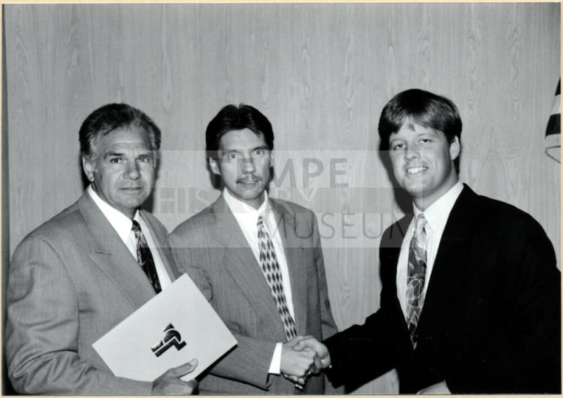 Joseph Lewis Shaking Hands with Unidentified Man Next to Another Unidentified Man.