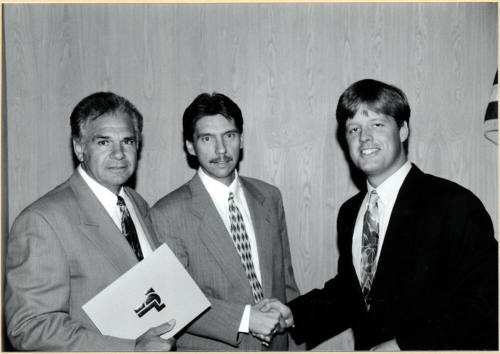 Joseph Lewis Shaking Hands with Unidentified Man Next to Another Unidentified Man.