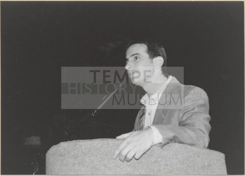 Black and White Photo of Neil Giuliano Speaking at a Podium.
