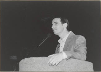Black and White Photo of Neil Giuliano Speaking at a Podium.